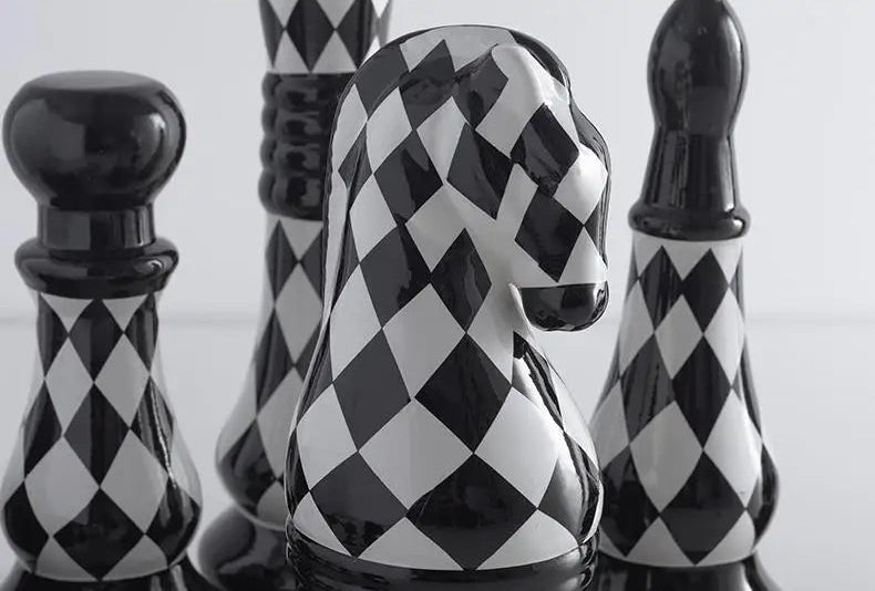 Black and white checkered chess pieces on a light background