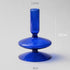 Blue glass object with measurements on a gray background