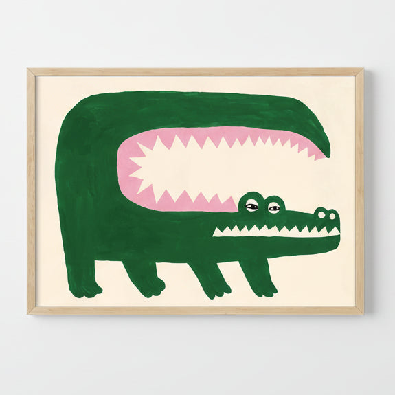 Framed illustration of a green alligator with a pink interior on a beige background