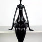 Black mannequin on a white shelf against a white background