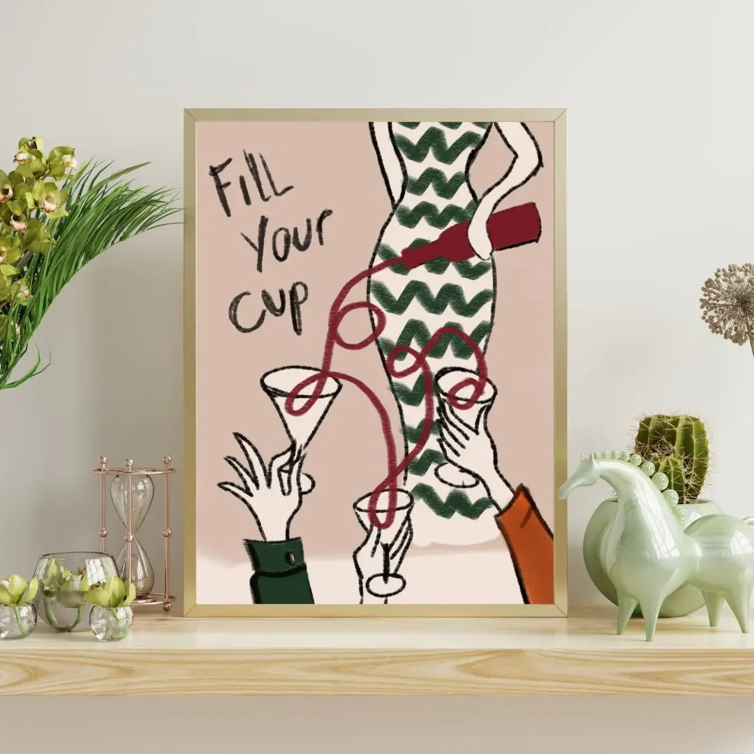 Framed artwork with a drink-themed design on a shelf with decorative items.