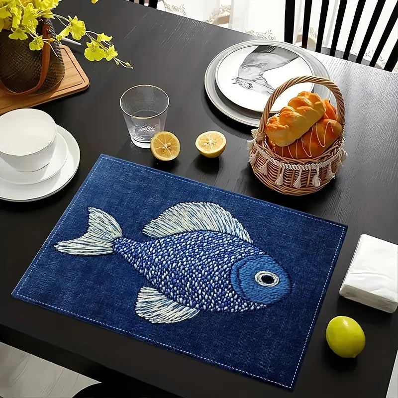 Blue fish placemat on a dining table with bread basket and lemons
