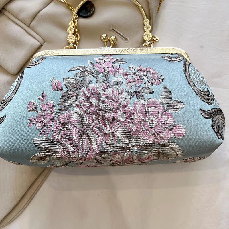 Floral embroidered clutch bag on a light background