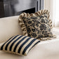 Decorative pillows with floral pattern and stripes on a beige sofa.