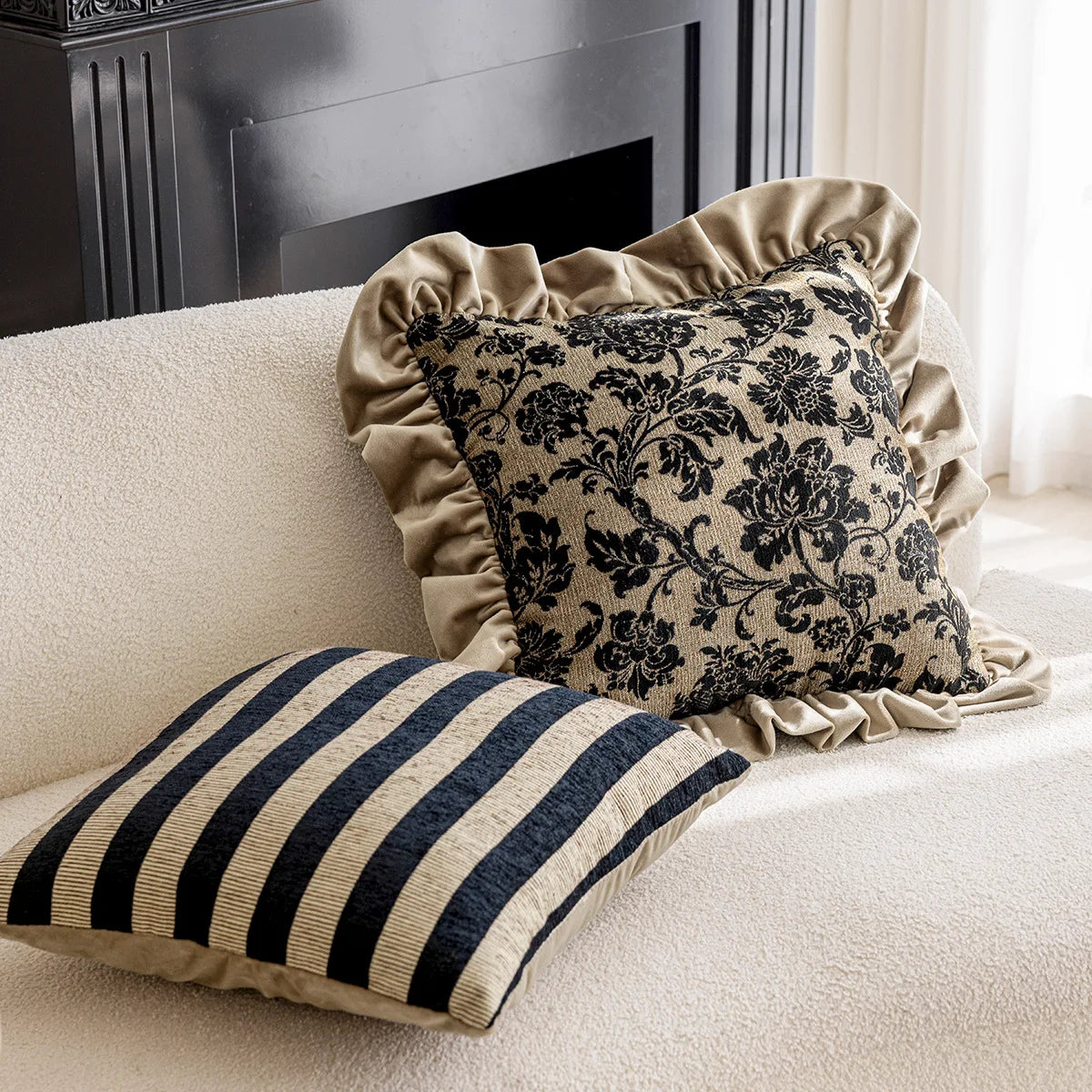 Decorative pillows with floral pattern and stripes on a beige sofa.