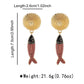 Gold and red fish-shaped earrings with measurements on a white background