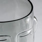 Clear glass container with a smooth, transparent surface on a gray background