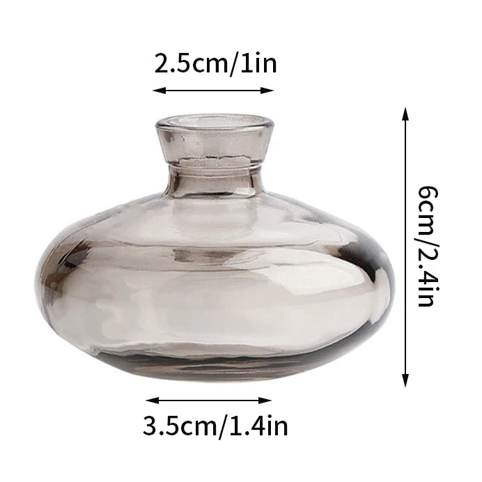 Clear glass vase with measurements on a white background