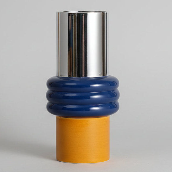 A set of ceramic vases in different sizes with a blue and white Morandi-style pattern, and a wooden piece with orange and yellow details.