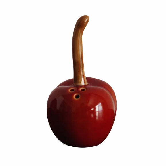 Red ceramic fish with a wooden handle on a white background