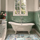 Bathroom with green tiled walls, a freestanding bathtub, and a window.