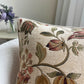 Decorative pillow with floral pattern on a neutral background