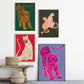 Four colorful animal prints of tigers, leopards, and a cheetah on a wall.