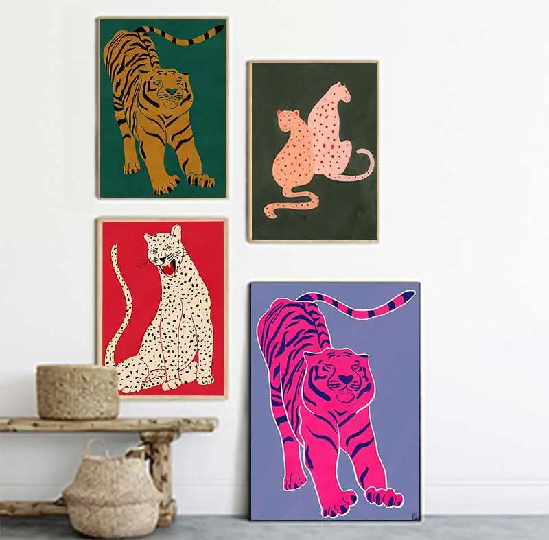 Four colorful animal prints of tigers, leopards, and a cheetah on a wall.