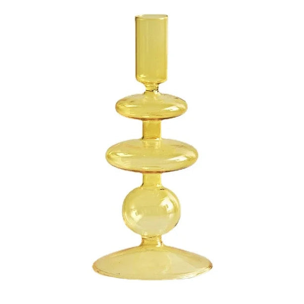 A yellow glass candle holder with a floral design, suitable for home or wedding decoration.