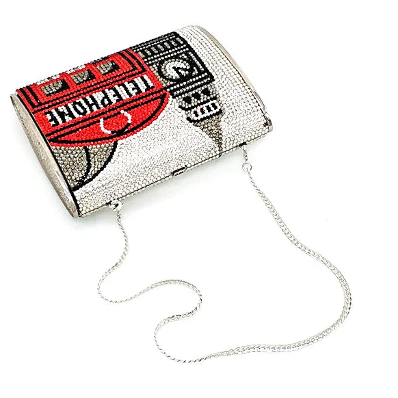 Designer handbag with intricate pattern and chain strap on a white background