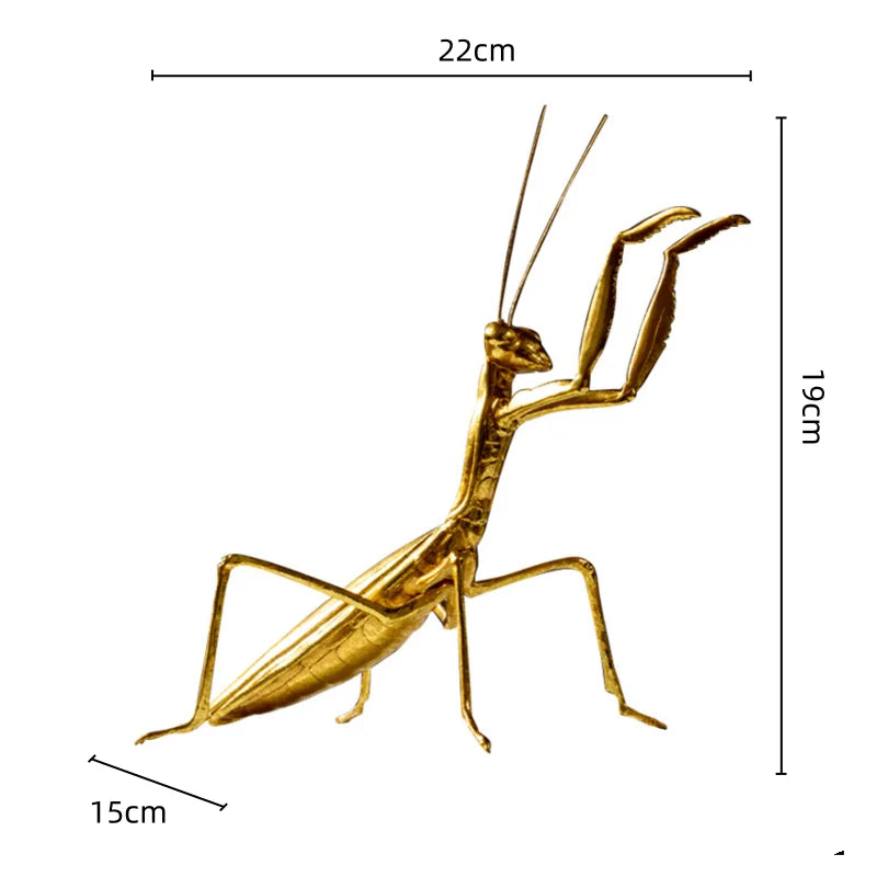 Gold praying mantis figurine with measurements on a white background