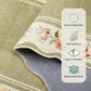 Floral-patterned rug with non-slip backing features on a beige surface