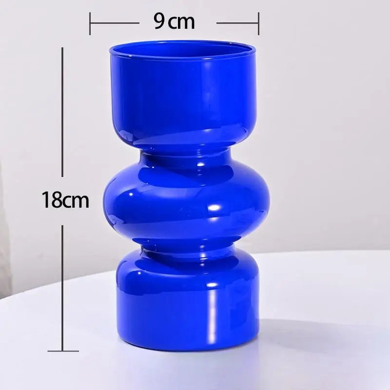 Blue cylindrical vase with measurements on a white background