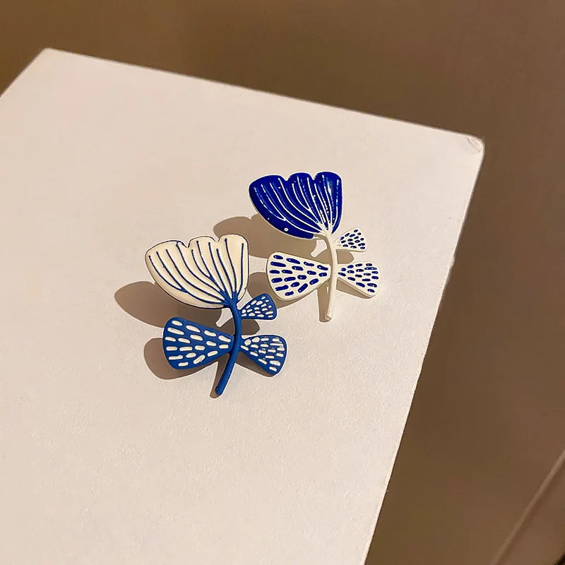 asymmetric flower stud earrings drip glaze jewelry styled product view