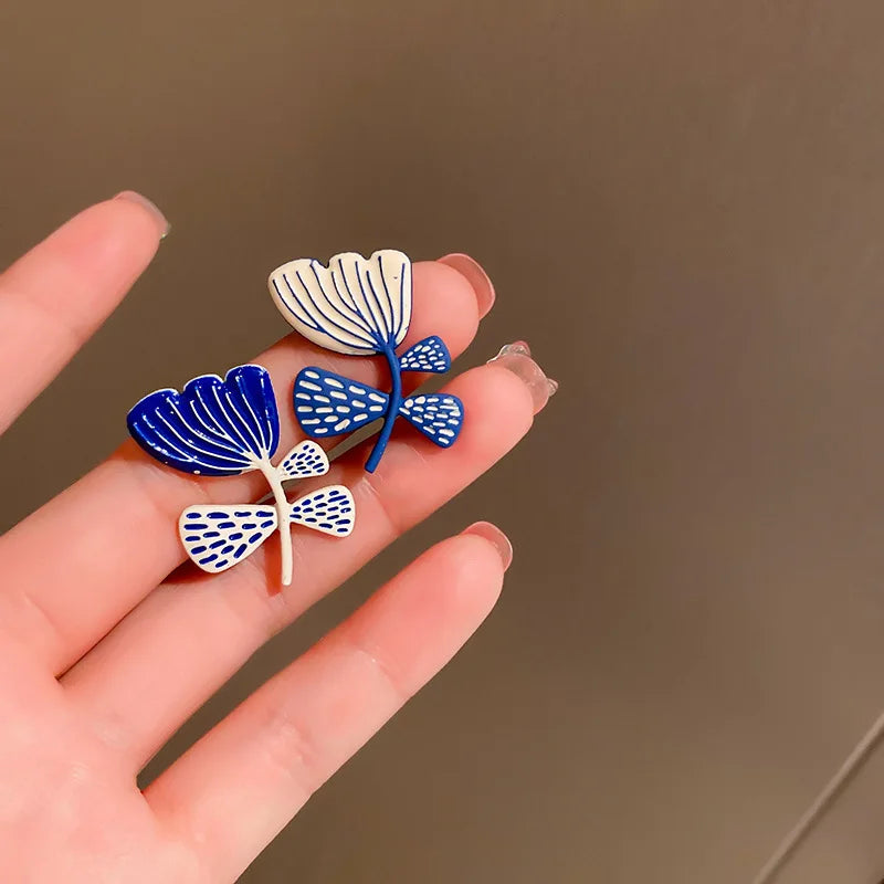 asymmetric flower stud earrings drip glaze jewelry detail product view