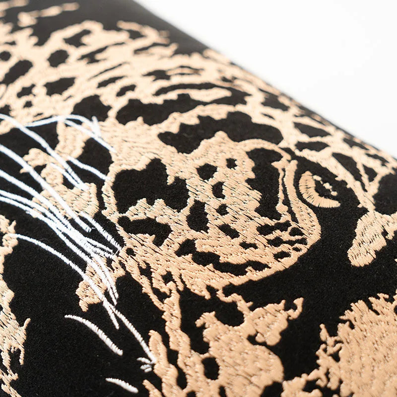 Gold leopard embroidery detail on black decorative cushion cover