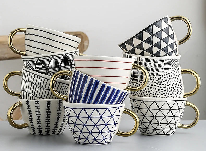 Set of ceramic mugs with geometric patterns on a light gray background