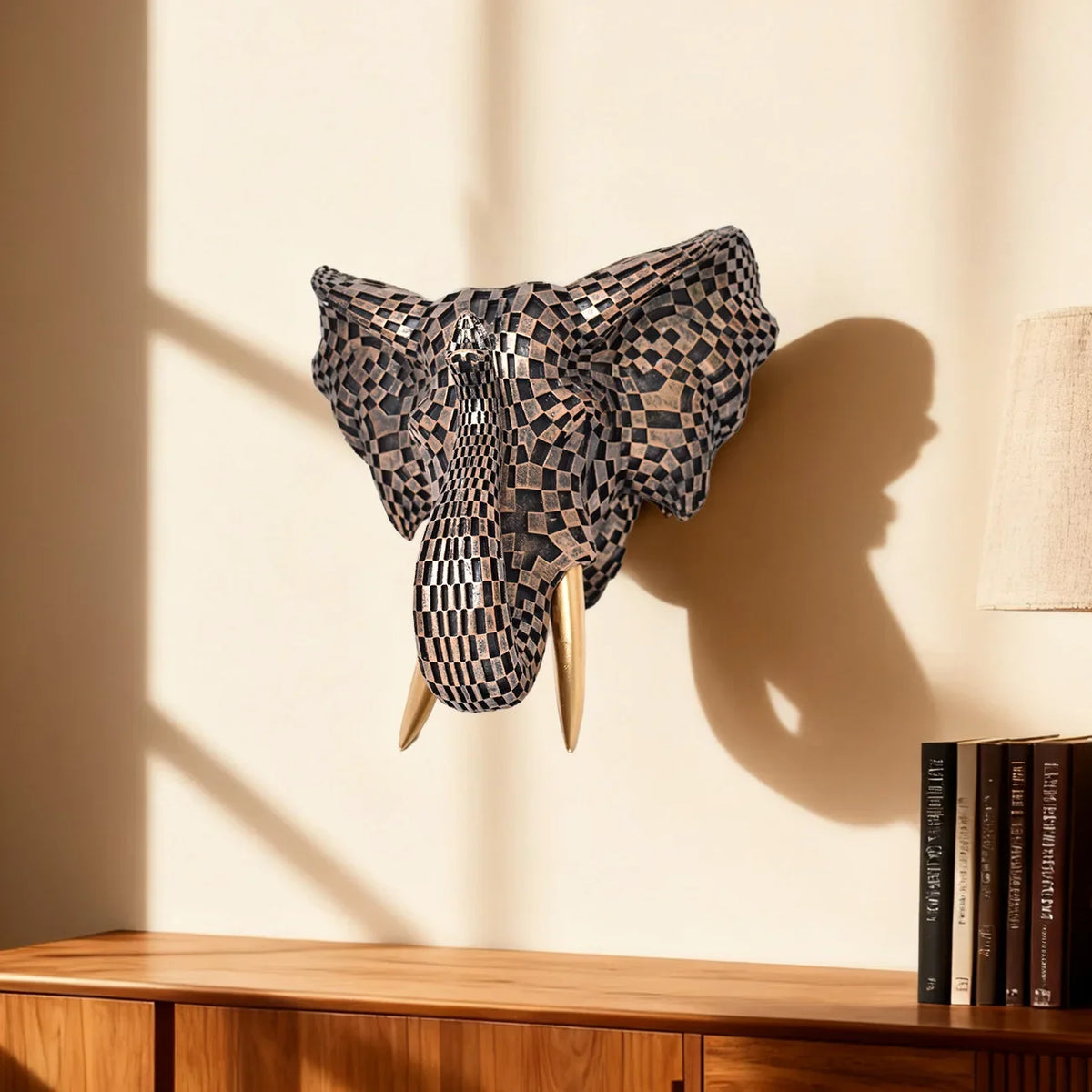 Decorative elephant head mounted on a wall with books below - alternate view 3