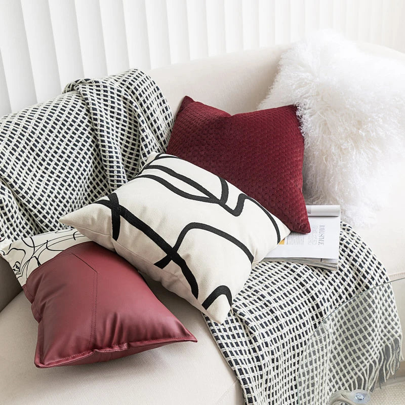 Neutral cream cushion cover with bold black abstract line pattern