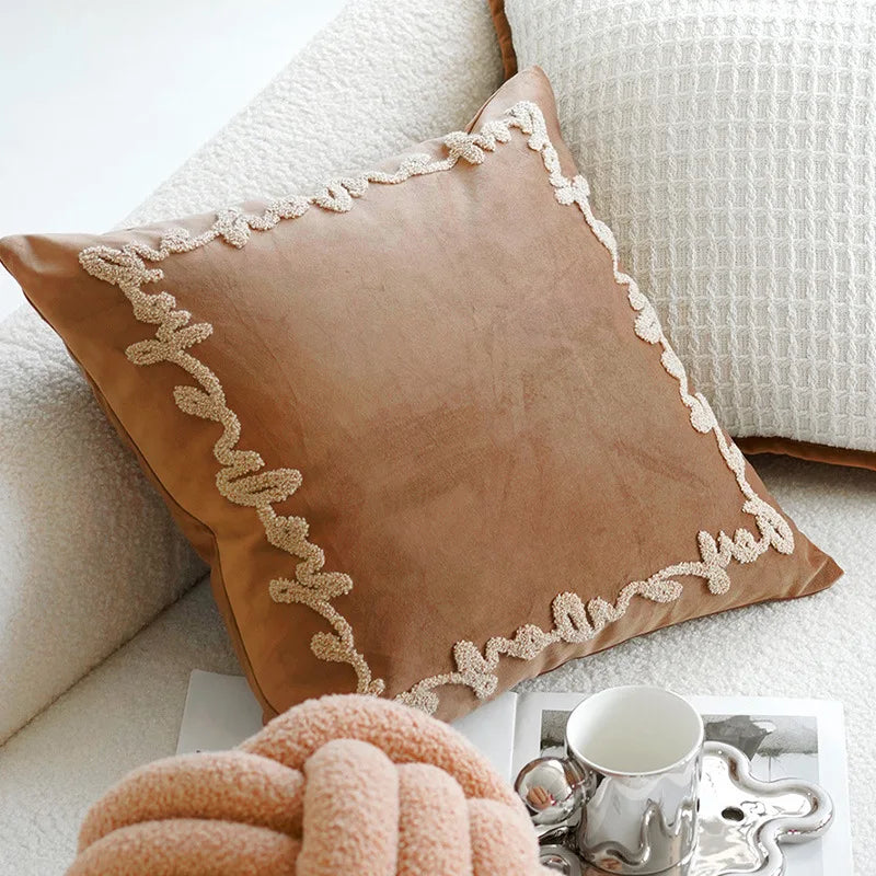 Textured cream geometric pillowcase detail with embroidered neutral pattern