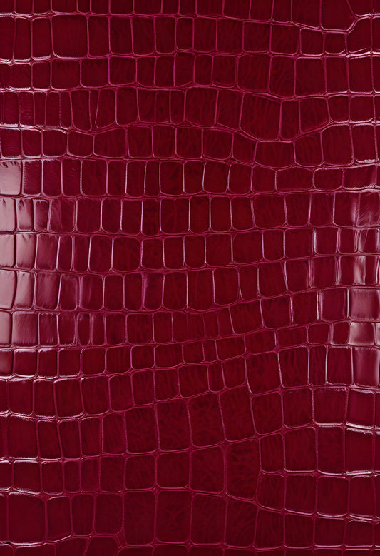Rich burgundy crocodile leather texture with intricate patterns showcasing luxury and craftsmanship