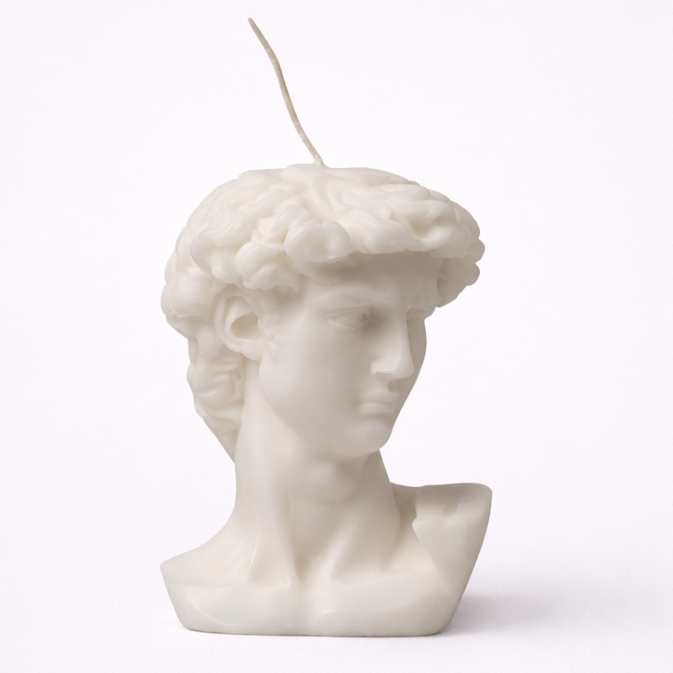 Candle shaped like a classical bust on a white background