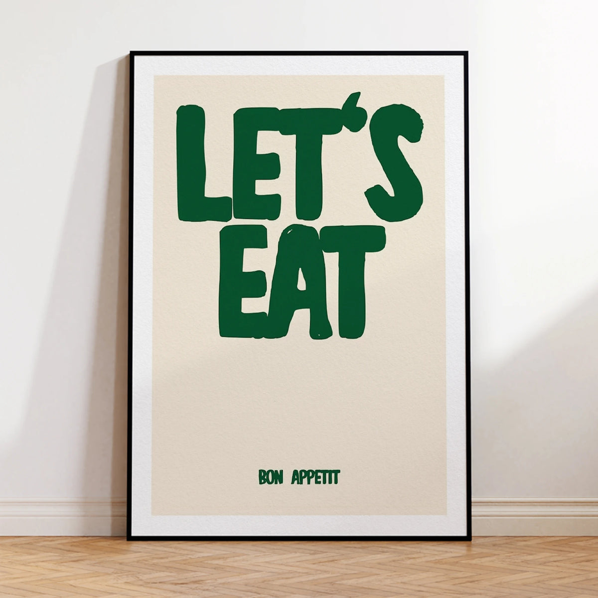 Framed poster with 'LET'S EAT' and 'BON APPETIT' text on a beige background