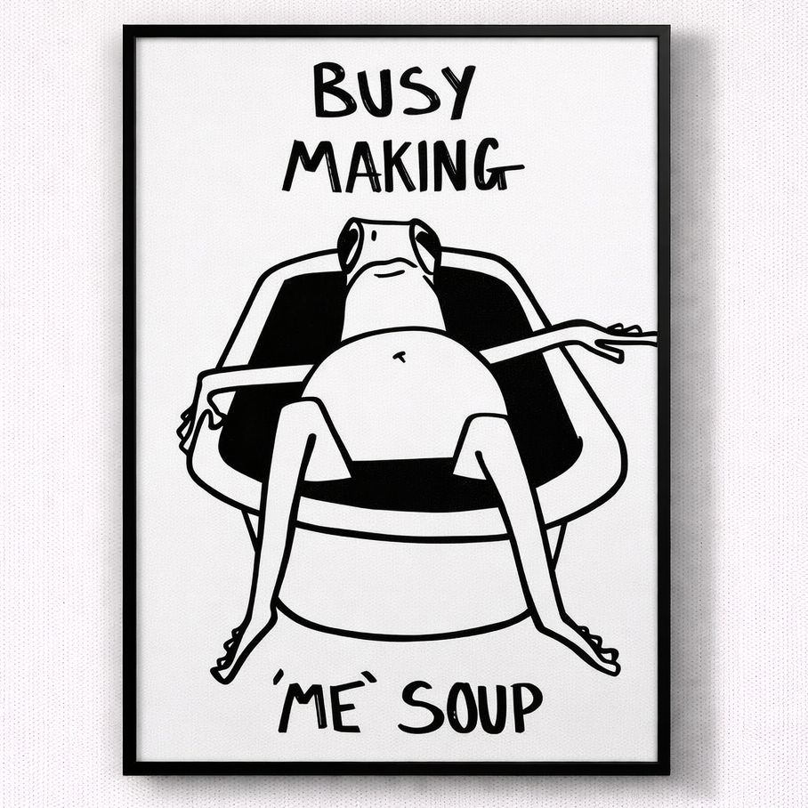 Framed black and white illustration of a person sitting in a chair with text 'BUSY MAKING ME SOUP' on a light gray background.