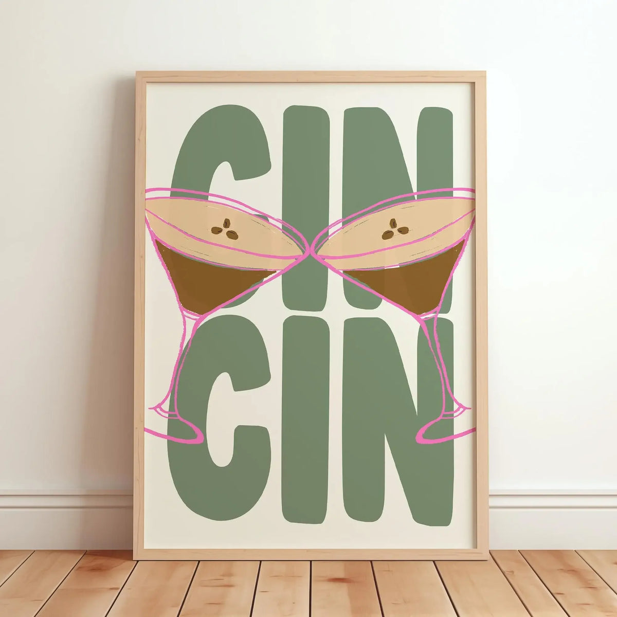Framed artwork with a design of a bikini and the word 'GIN' on a plain wall.