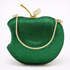 Green apple-shaped handbag with gold accents on a white background