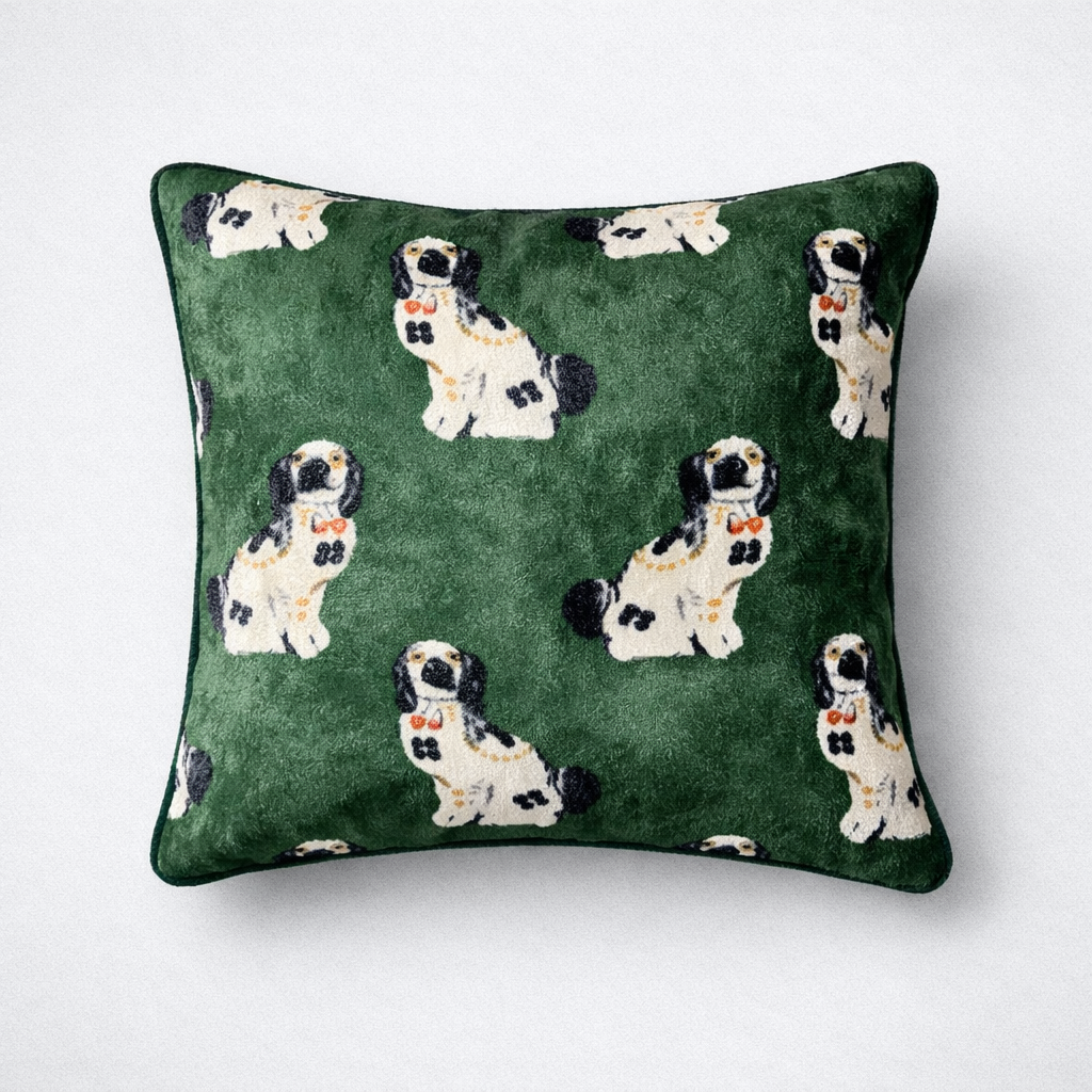 Green cushion cover with repeating white and black dog pattern