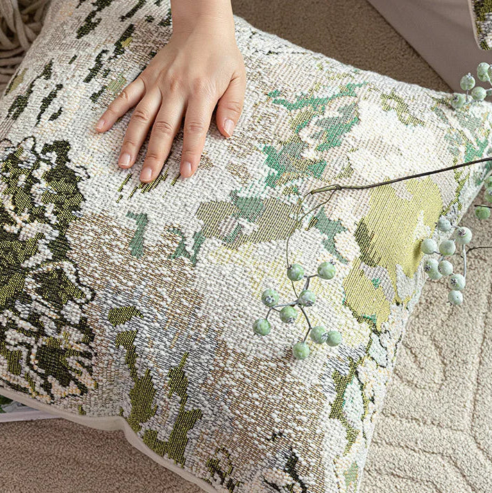 Decorative pillow with a floral pattern on a textured surface.