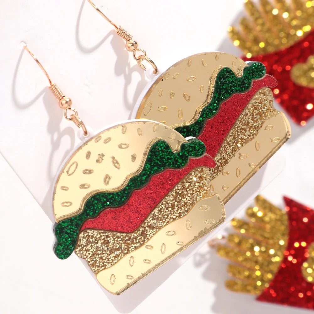 Taco-shaped earrings with gold, red, and green glittery design on a white background.