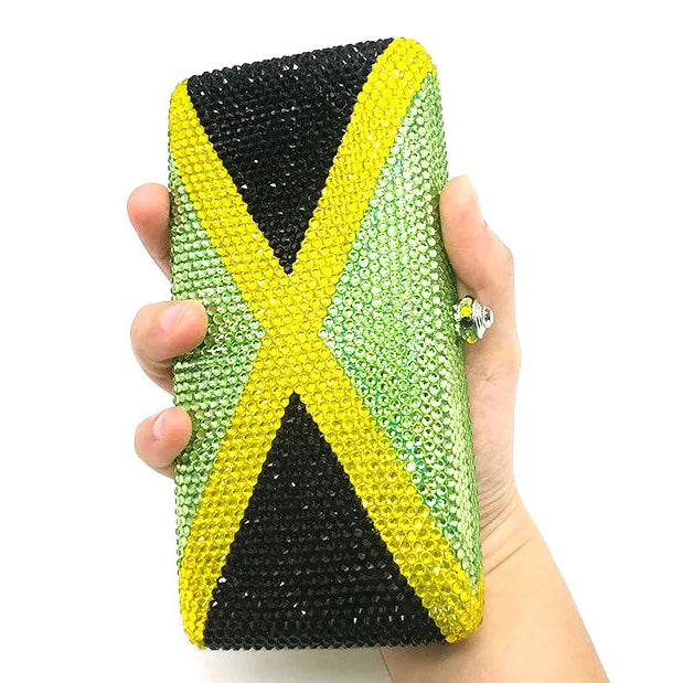 Hand holding a clutch with the design of the Jamaican flag.