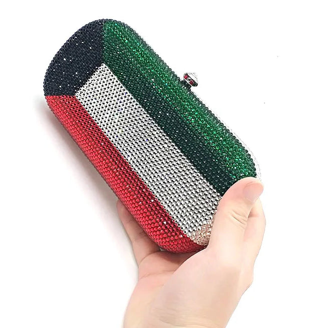 Colorful beaded clutch held by a hand on a white background