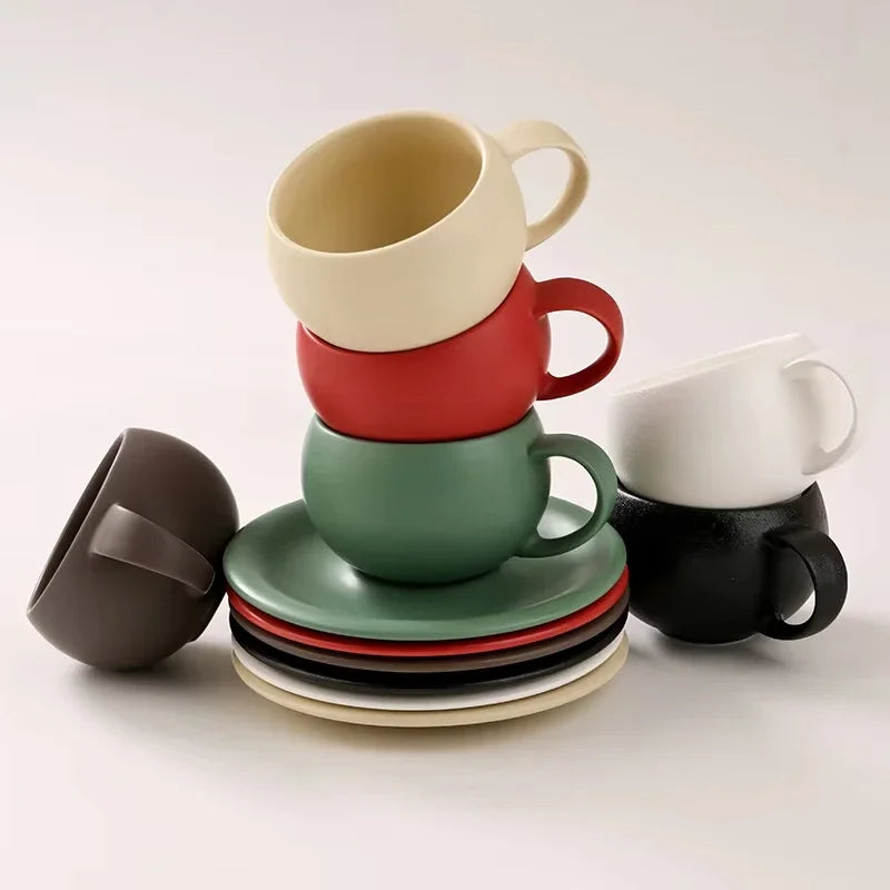 Stacked ceramic mugs and saucers in various colors on a white background