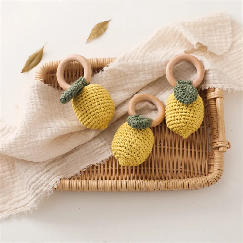 Crochet lemon infant toy with natural wooden grasping ring and textured cotton finish