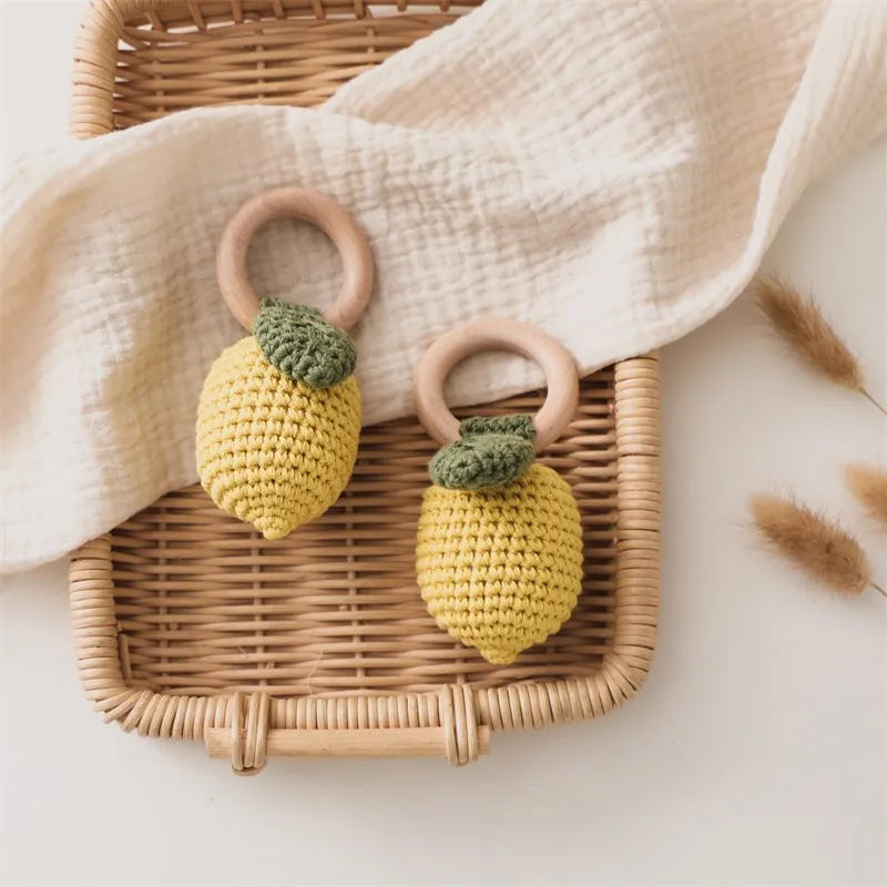 Lemon shaped crochet newborn rattle with smooth wooden ring for supervised activity