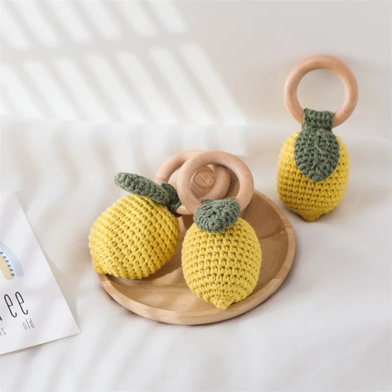 Yellow crochet fruit baby toy with wooden ring for nursery play and gifting