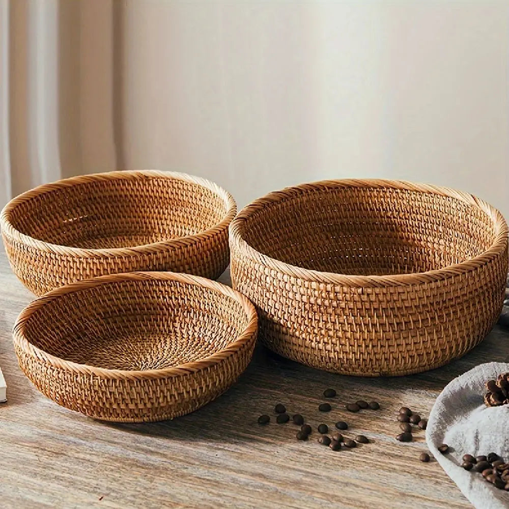Three woven baskets on a wooden surface with scattered coffee beans.