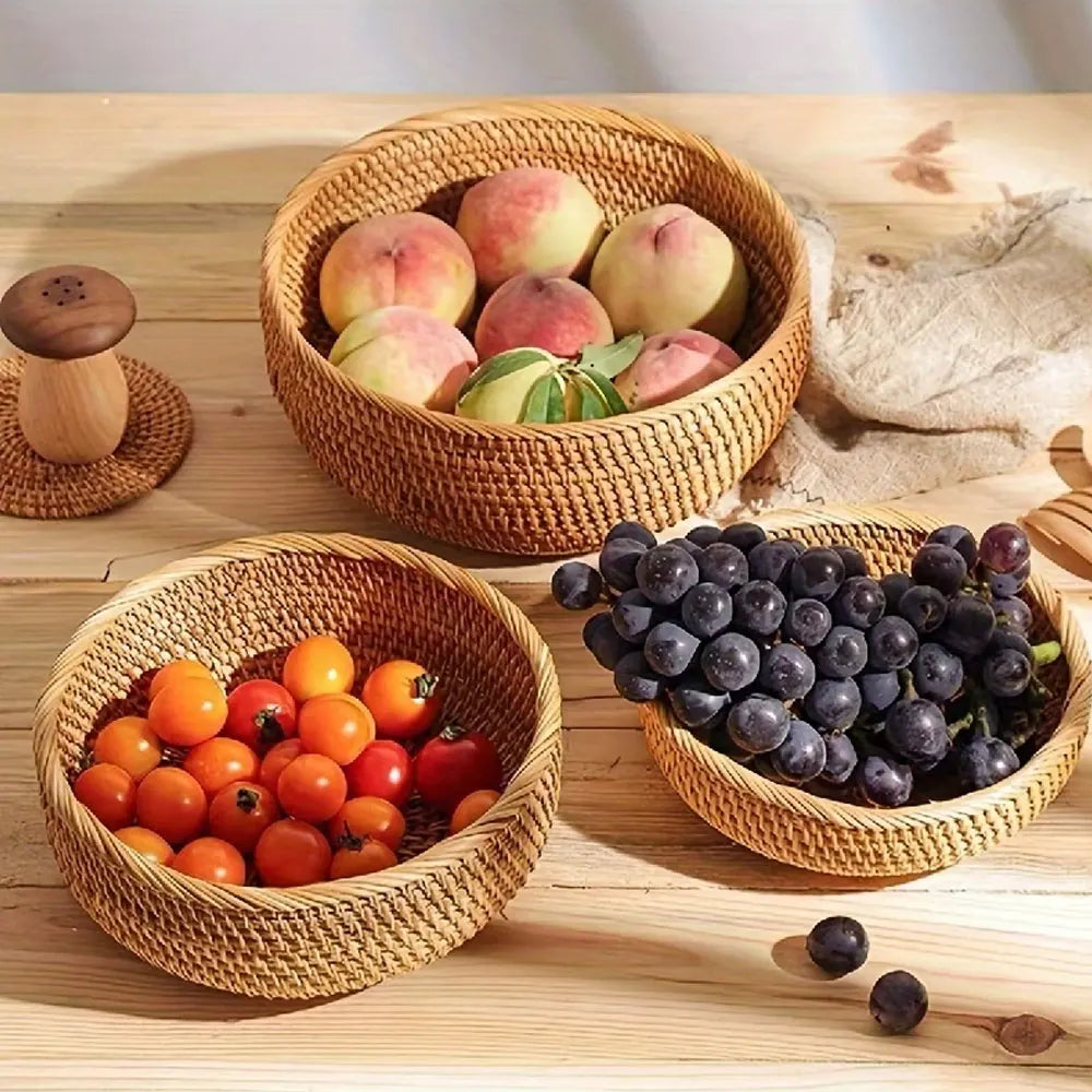 Three woven baskets filled with fruits on a wooden surface