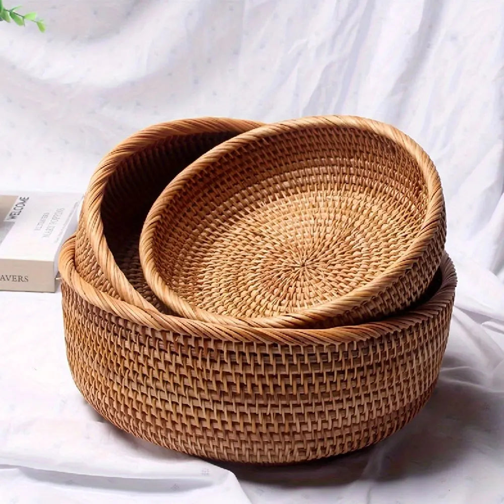 Two woven baskets stacked on a white surface