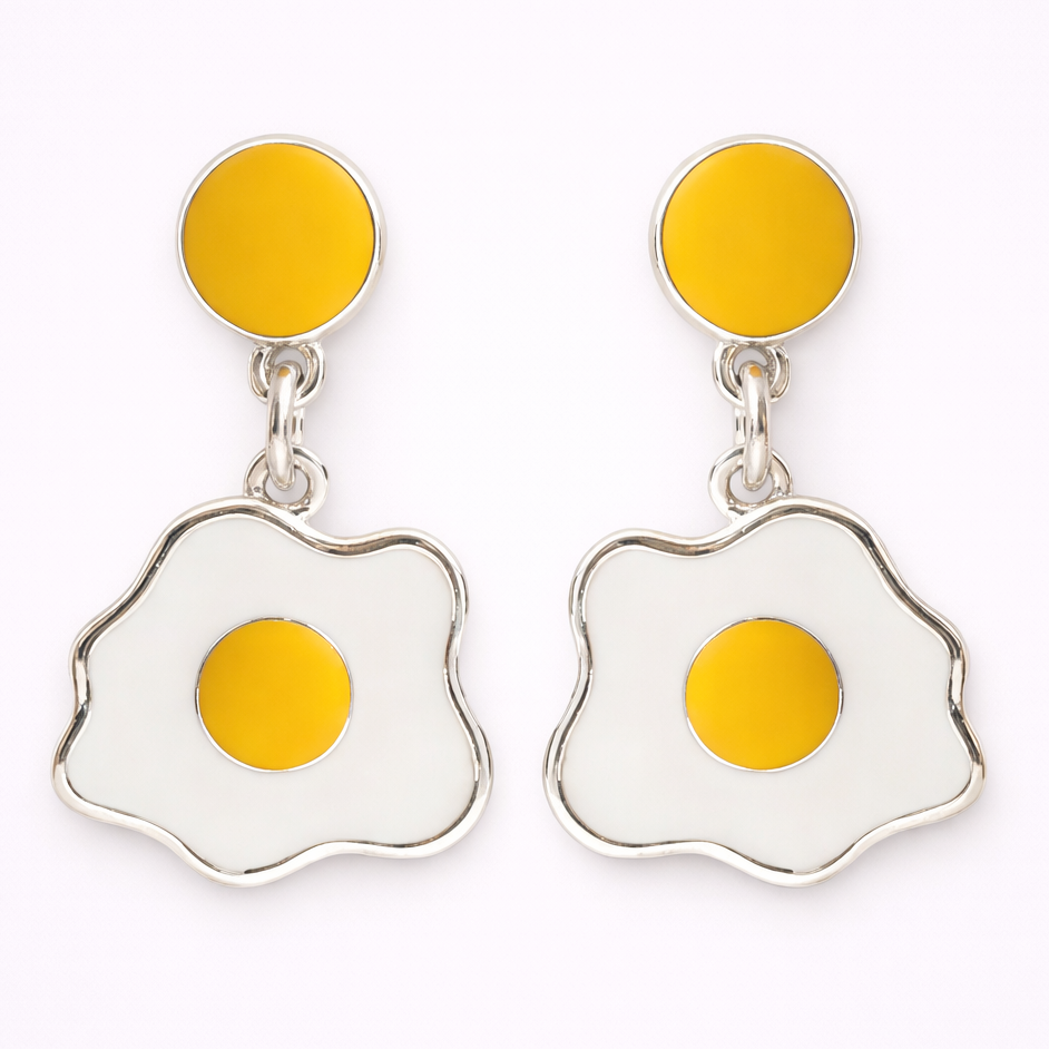 Fried egg-shaped earrings with yellow centers on a white background