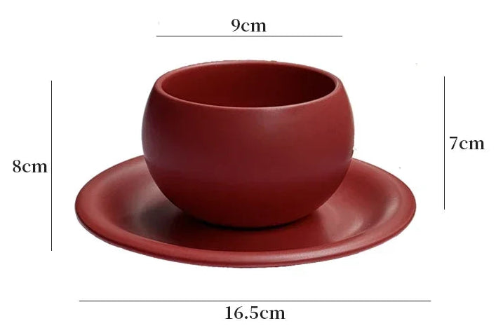 Red ceramic cup and saucer with dimensions on a white background